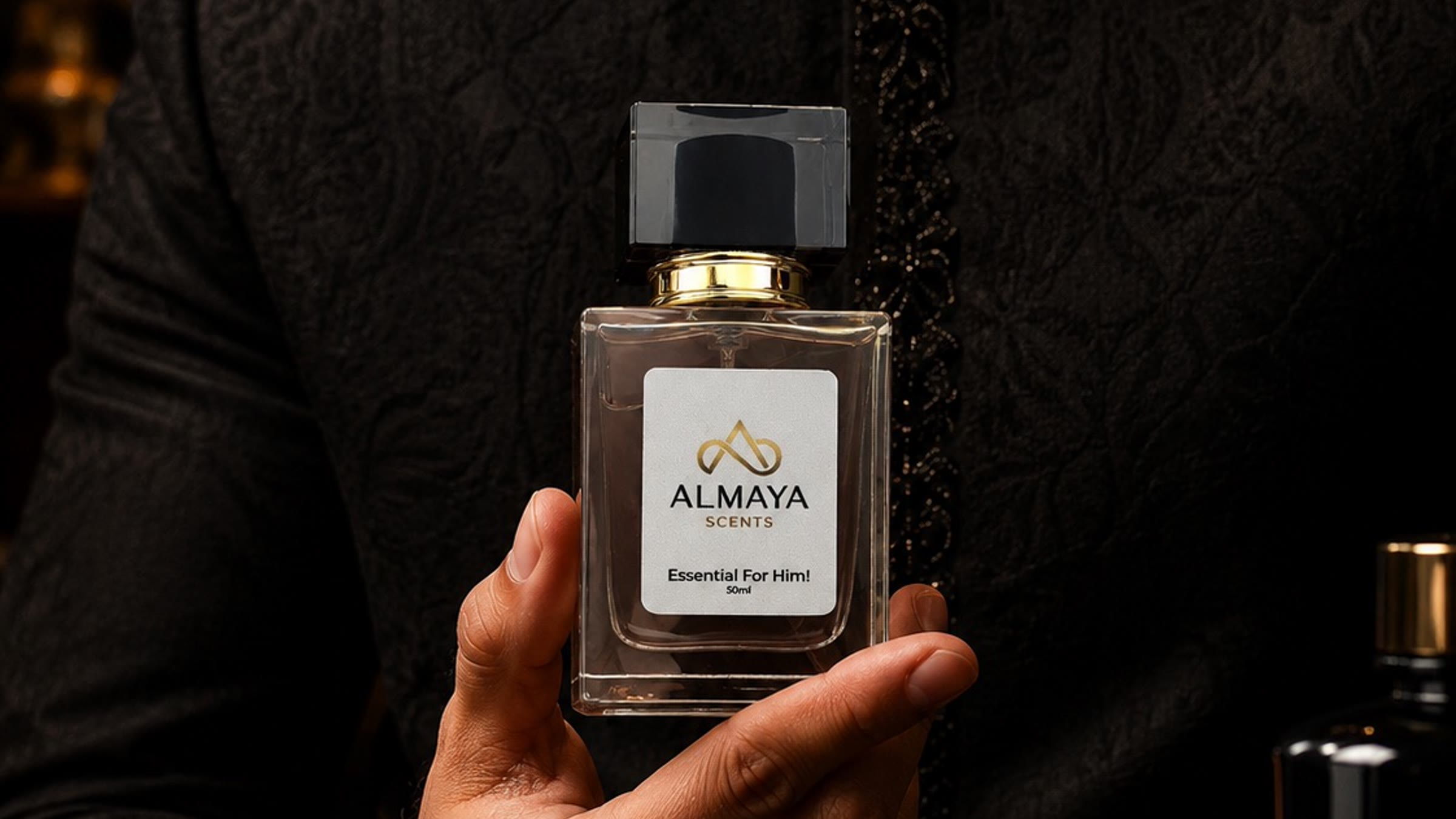 Essential For Him held against deep embroidered black formalwear