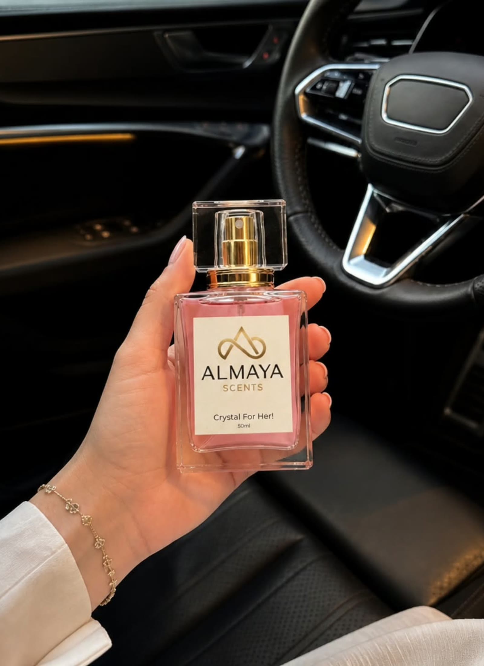 Crystal For Her held in a dark car interior with warm amber light